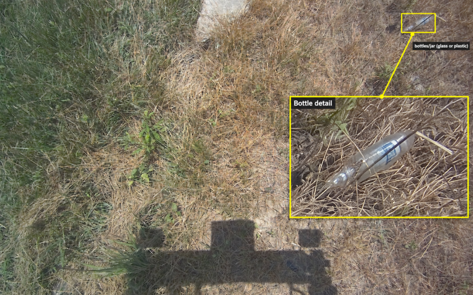 Labeled bottle detection in grass with an enlarged detail.